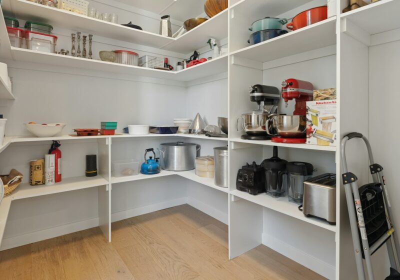 a white kitchen with white shelves