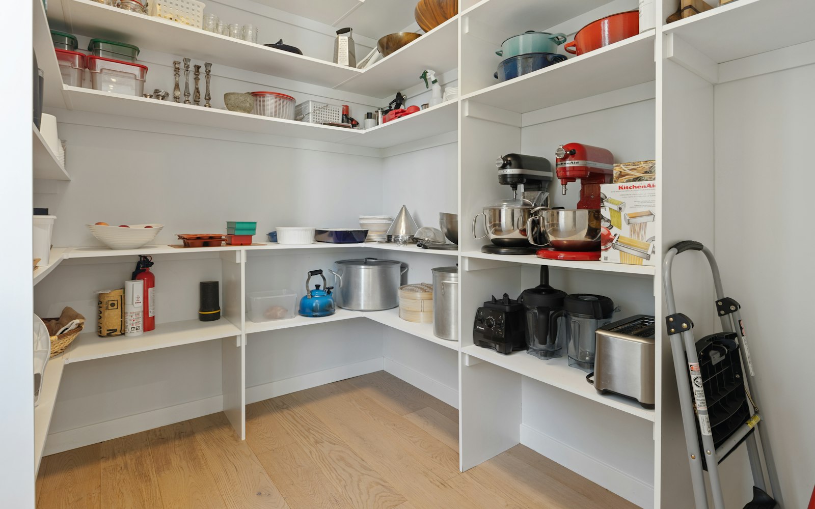 a white kitchen with white shelves
