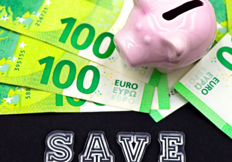 A piggy bank on euro bills with 'save' text highlights money saving concepts.