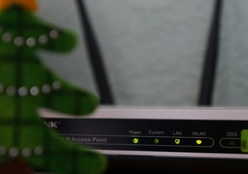 white and black modem router with four lights