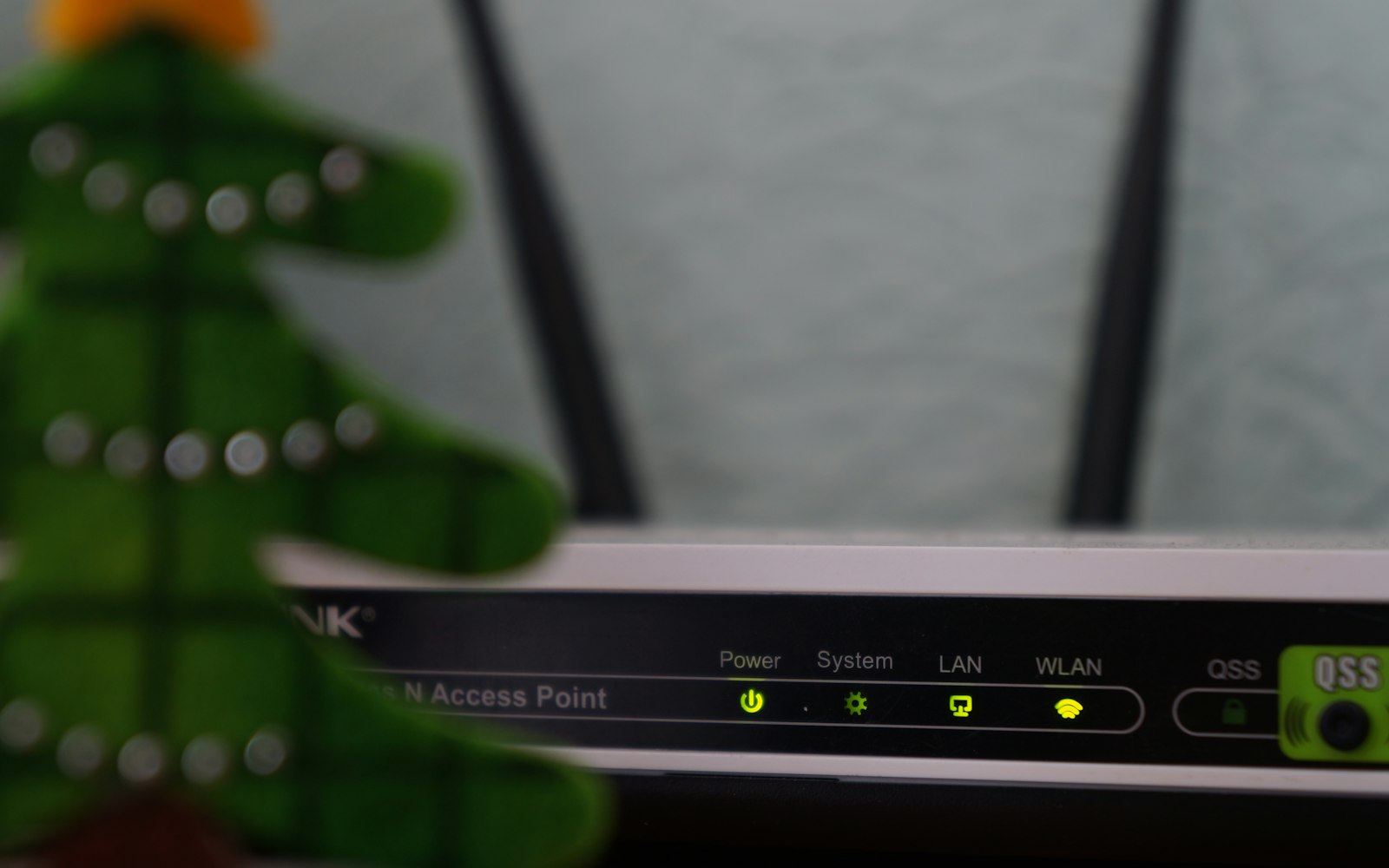 white and black modem router with four lights