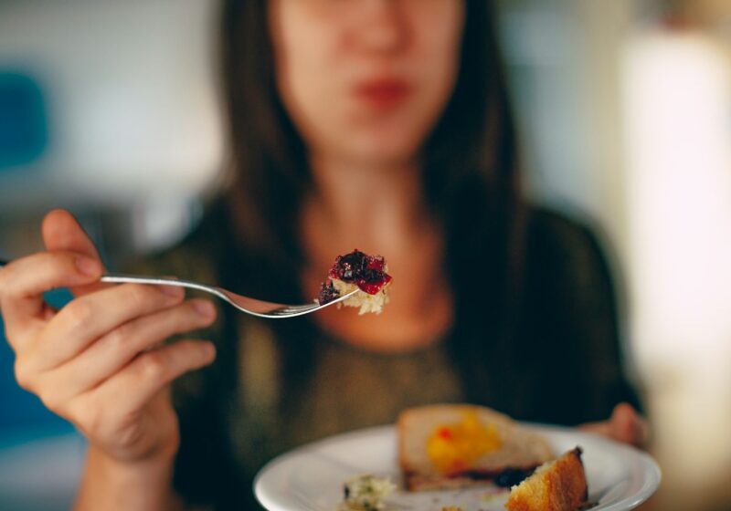 woman holding plate of cake