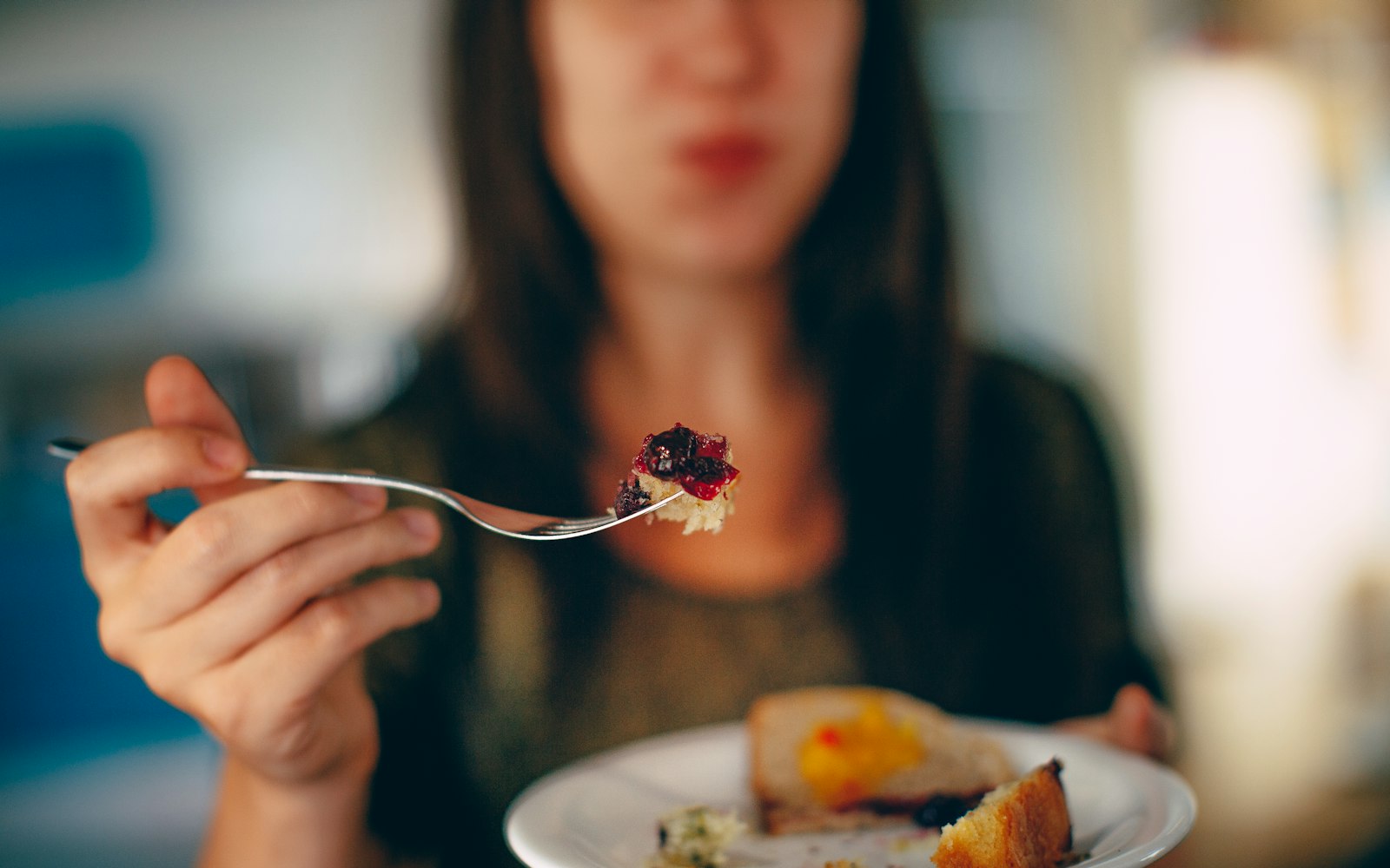 woman holding plate of cake