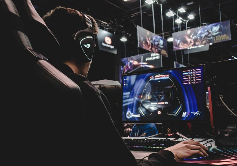 person sitting on gaming chair while playing video game