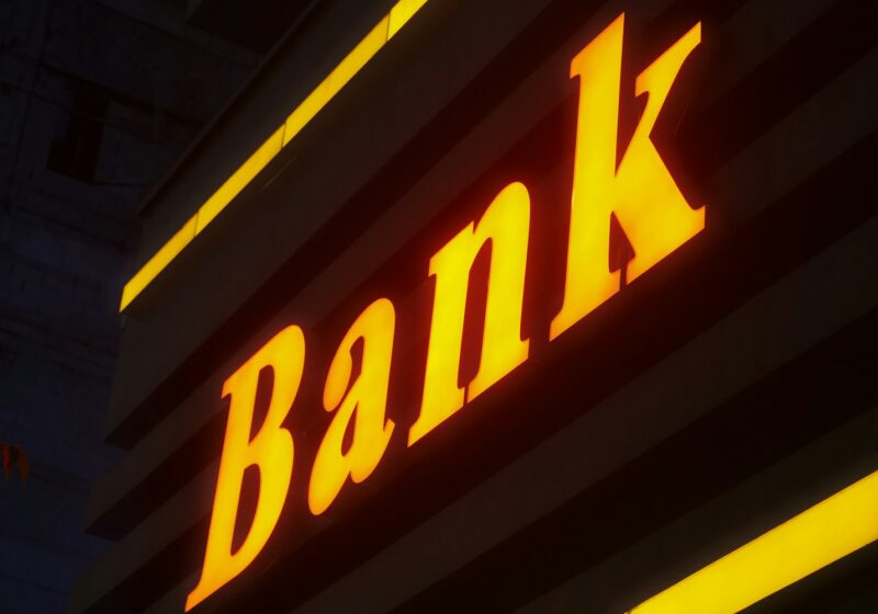 a bank sign lit up in the dark