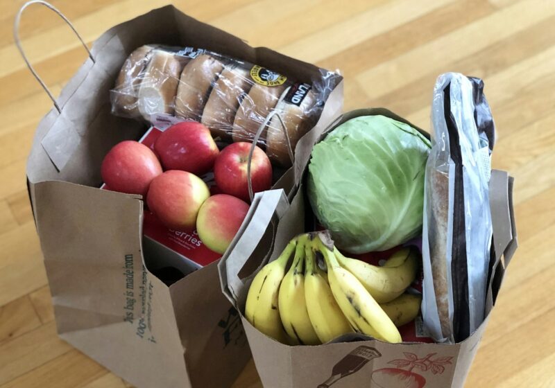 apples and bananas in brown cardboard box