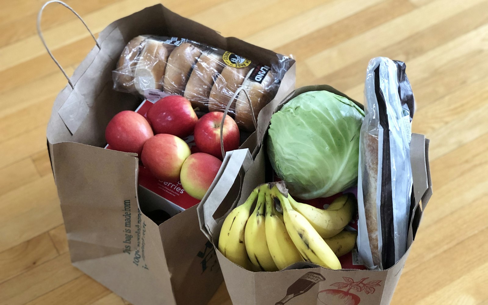 apples and bananas in brown cardboard box
