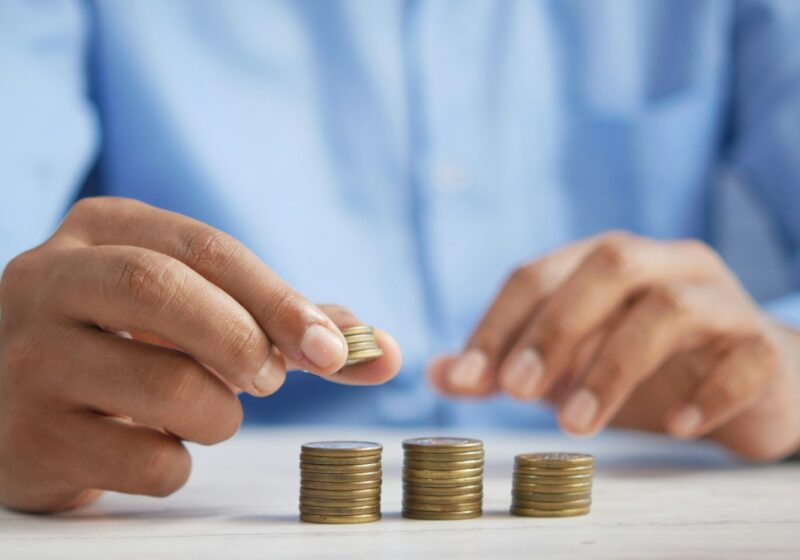 a person stacking coins on top of a table