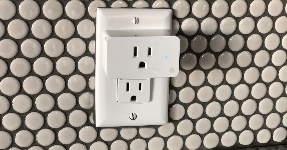 Close-up of a smart plug on a tiled wall showcasing contemporary interior design style.